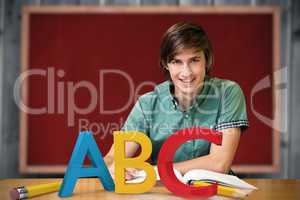 Composite image of student sitting in library reading