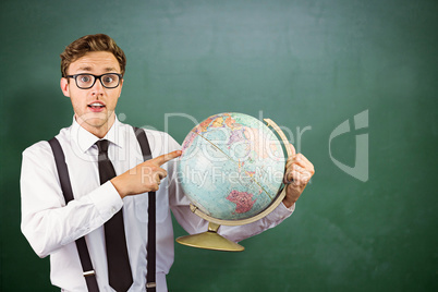 Composite image of geeky businessman pointing to globe