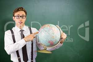 Composite image of geeky businessman pointing to globe