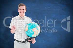 Composite image of geeky hipster holding a globe