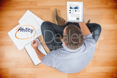 Ability  against young creative businessman looking at tablet