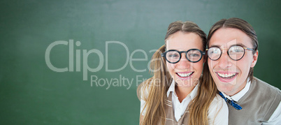 Composite image of geeky hipsters smiling at camera