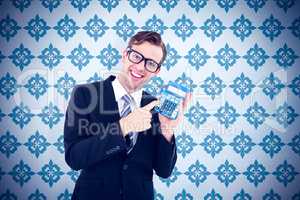 Composite image of geeky businessman pointing to calculator