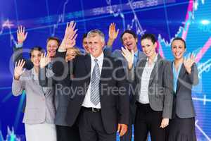 Composite image of smiling business team waving at camera