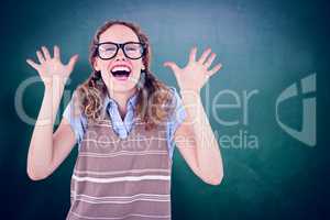 Composite image of geeky hipster woman smiling and showing her h