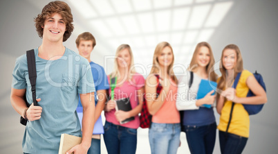 Composite image of a man standing in front of his friends as he