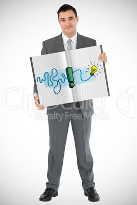 Composite image of businessman showing a book