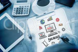 Composite image of man writing on clipboard on working desk