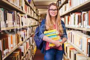 Composite image of pretty student in the library