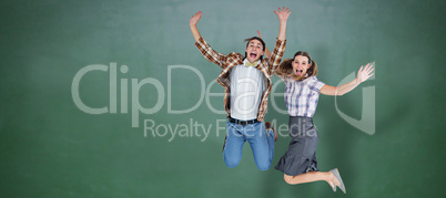 Composite image of geeky hipsters jumping and smiling