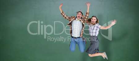 Composite image of geeky hipsters jumping and smiling