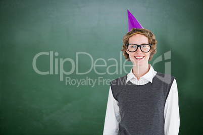 Composite image of geeky hipster wearing a party hat