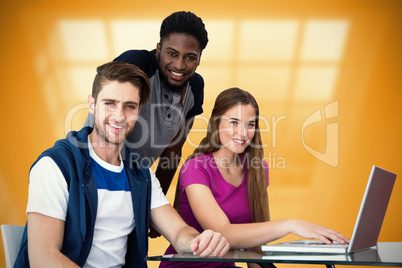 Composite image of creative team using laptop
