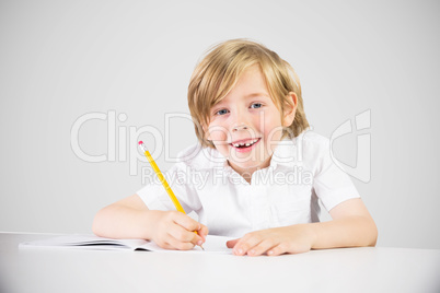 Composite image of cute pupil writing