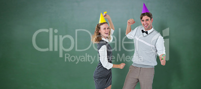 Composite image of geeky couple dancing with party hat