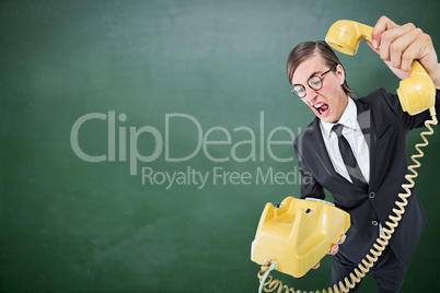 Composite image of geeky businessman shouting and hanging up the