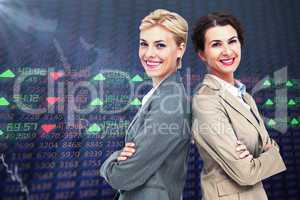 Composite image of serious businesswomen standing back on back