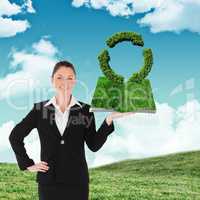 Composite image of woman holding lawn book