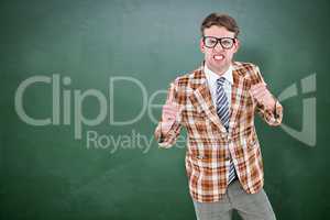 Composite image of angry geeky hipster looking at camera