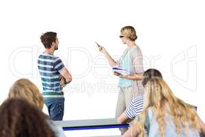 Composite image of student and teacher pointing at blackboard in