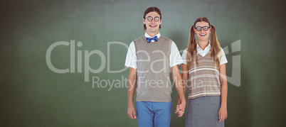 Composite image of geeky hipster couple holding hands
