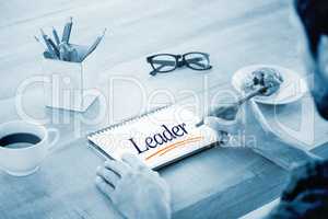 Leader against creative businessman writing notes on notebook