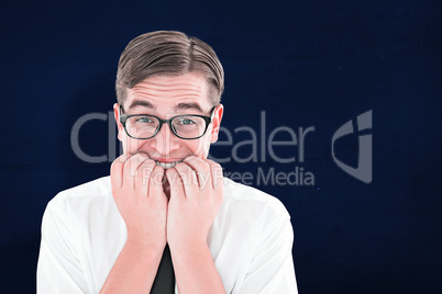 Composite image of geeky businessman looking nervously at camera