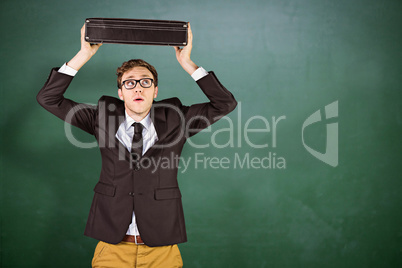 Composite image of young geeky businessman holding briefcase