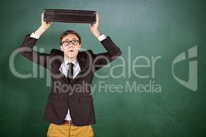 Composite image of young geeky businessman holding briefcase