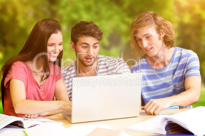 Composite image of college students using laptop in library