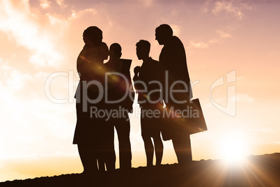 Composite image of silhouettes standing