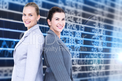Composite image of attractive businesswomen standing back-to-bac