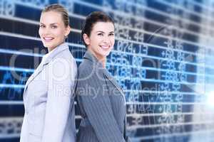 Composite image of attractive businesswomen standing back-to-bac