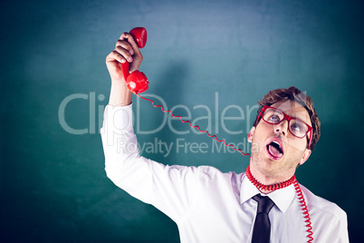 Composite image of geeky businessman strangling himself with tel