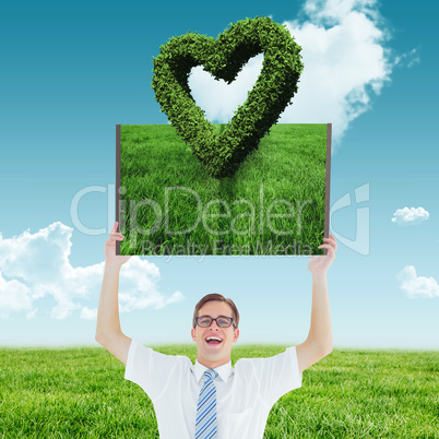 Composite image of man holding up lawn book