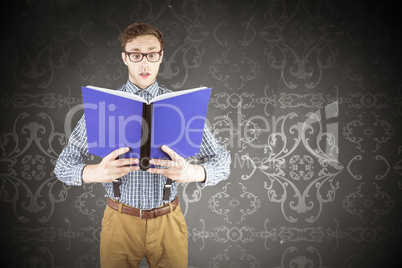 Composite image of geeky businessman reading a book