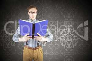 Composite image of geeky businessman reading a book