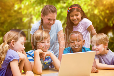 Composite image of cute pupils using tablet computer in library