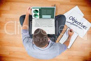 Objectives  against young creative businessman working on laptop