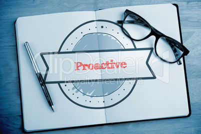 Proactive against overhead of open notebook with pen and glasses