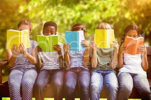 Composite image of children reading books at park