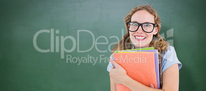 Composite image of geeky hipster woman holding files