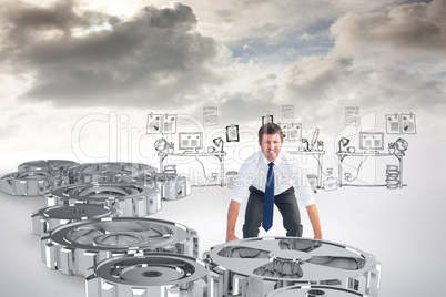 Composite image of businessman bending and lifting