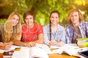 Composite image of college students doing homework in library