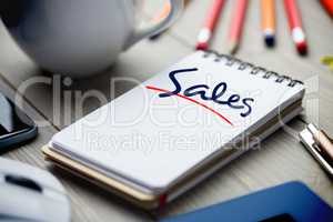 Sales against notepad on desk