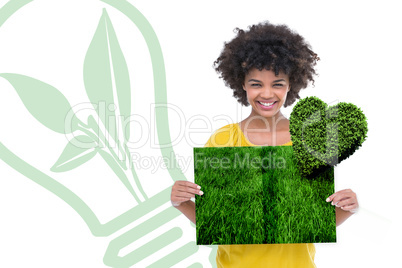 Composite image of woman holding lawn book