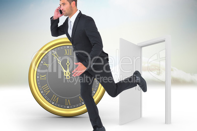 Composite image of businessman running on the phone