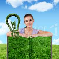 Composite image of woman with lawn book