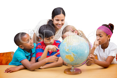 Composite image of cute pupils and teacher looking at globe in l