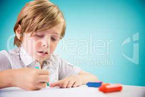 Composite image of cute boy colouring
